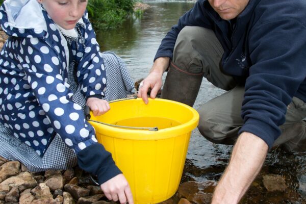 One of the year six pupils at Culmstock Primary School with John Hickey of the Westcountry Rivers Trust releasing salmon in to the river Culm  that the children have raised in the school classroom.
Credit Photo to Paul Glendell / Westcountry Rivers Trust 

Photo by Paul Glendell Tel 07802 480710