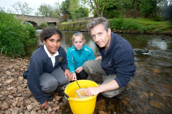 Year six pupils at Culmstock Primary School Elen Osborne (centre ) and Sofia Goodwill with John Hickey form the Westcounrty Rivers Trust  release salmon into the River Clum that the have raised  in the Classroom 
Credit Photo to Paul Glendell / Westcountry Rivers Trust 

Contact Photographer Paul Glendell 07802 480710